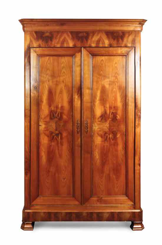 Appraisal: An American Cherry Armoire having a flared cornice over two