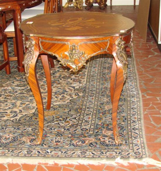 Appraisal: Continental mixed wood and marquetry center table shaped top centering