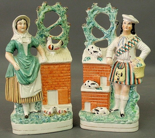 Appraisal: Pair of Staffordshire Scottish figural groups a woman with birds