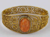 Appraisal: A gilt metal tests silver filigree coral cameo bracelet cameo