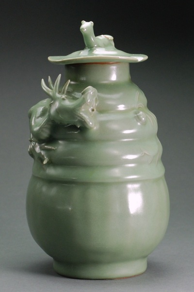 Appraisal: The pottery with thick celadon glaze and molded dragon climbing