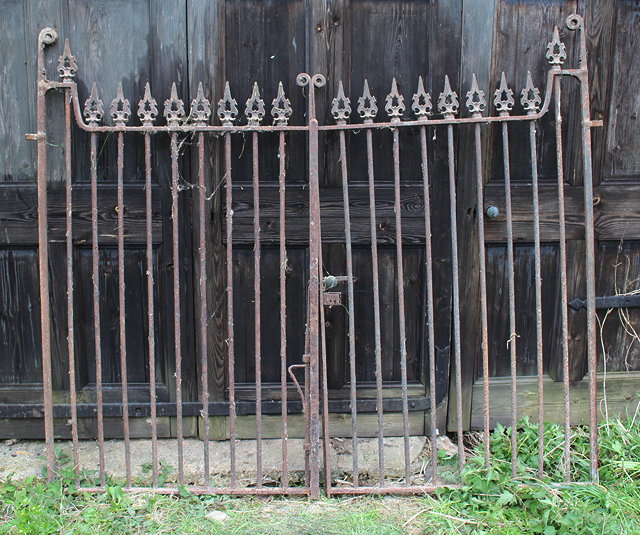 Appraisal: A PAIR OF VICTORIAN WROUGHT IRON DRIVEWAY GATES with cast