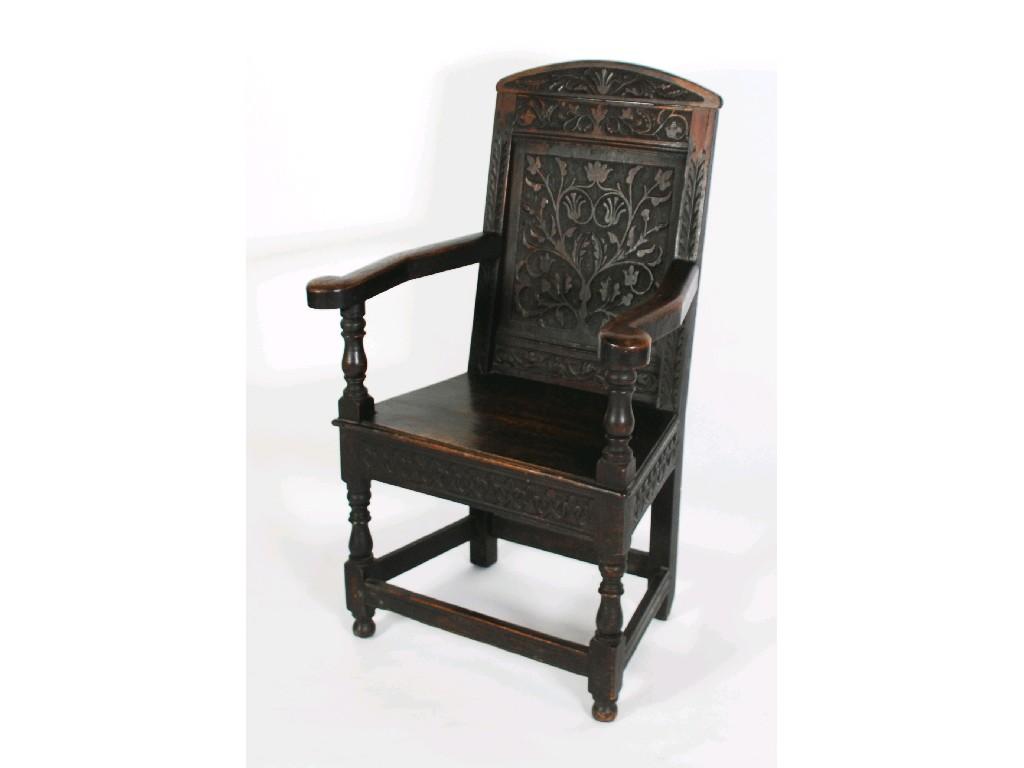 Appraisal: ANTIQUE AND LATER CARVED OAK COMPOSITE OPEN ARMCHAIR the arched