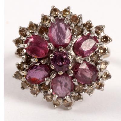 Appraisal: A ruby and diamond cluster ring the central seven-stone flowerhead