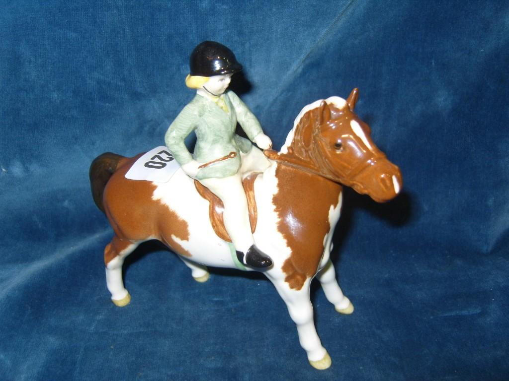 Appraisal: A Beswick model of a green jacketed little girl seated