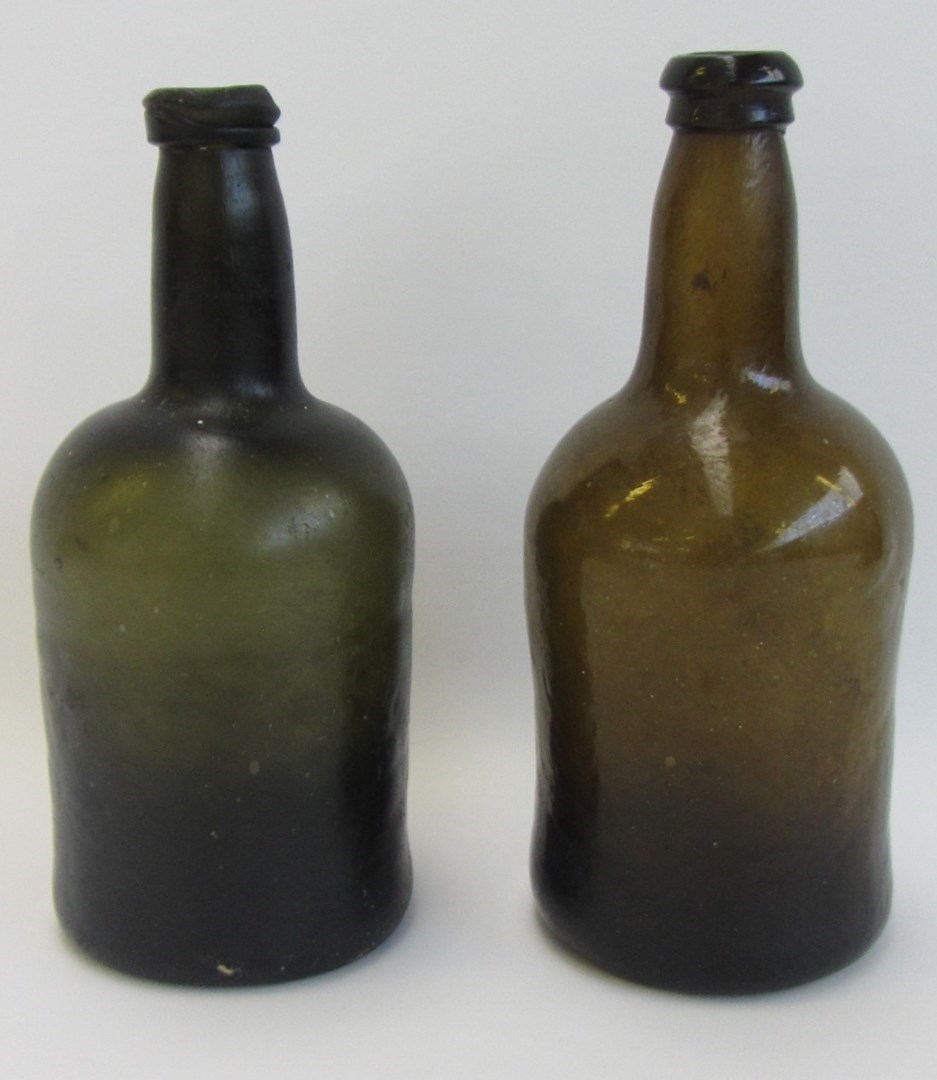 Appraisal: Two green glass cylindrical wine bottles late th th century