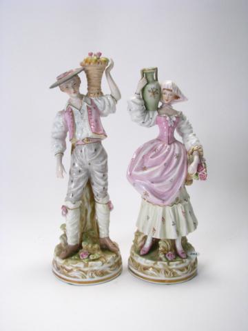 Appraisal: Pair of bisque porcelain figurines including man with fruit basket