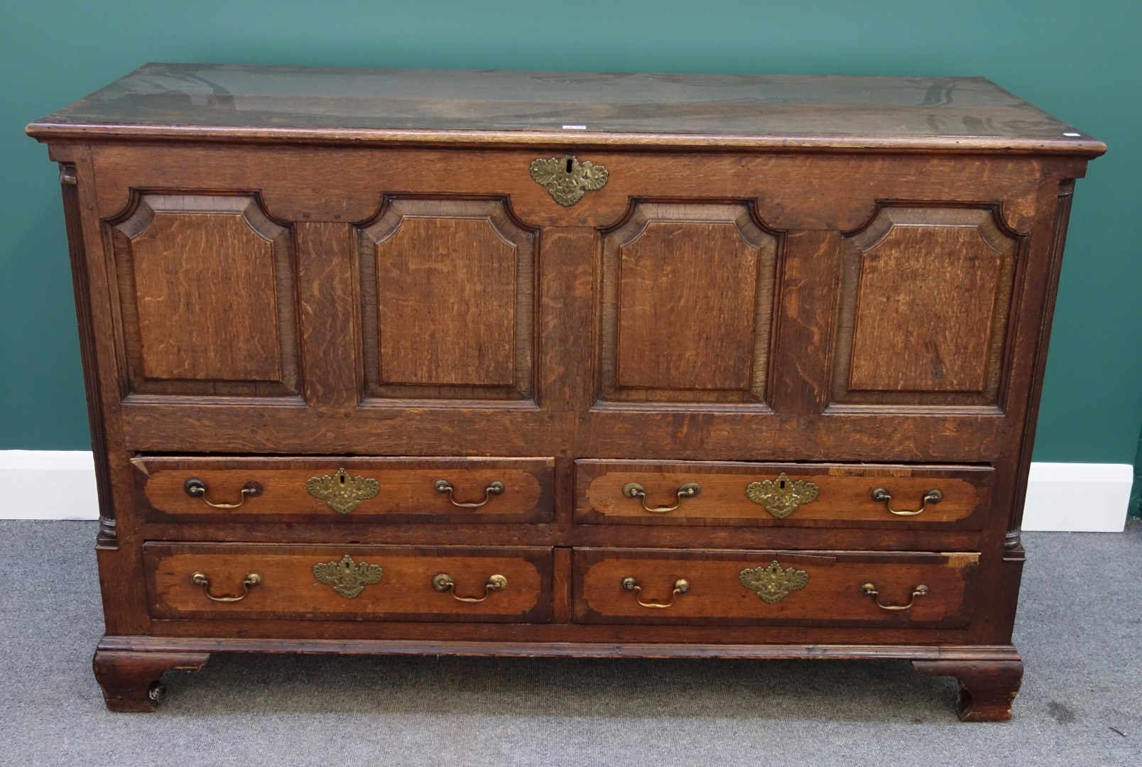 Appraisal: A mid th century crossbanded oak mule chest the lift