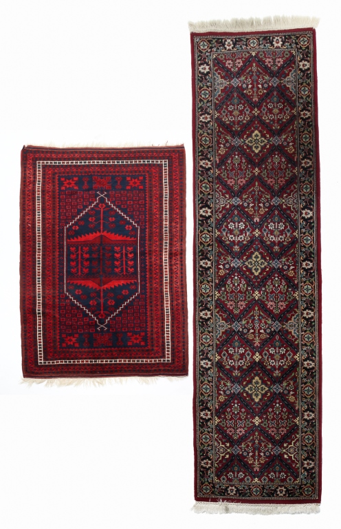 Appraisal: TWO ORIENTAL RUGS Late th century wool Burgundy runner with