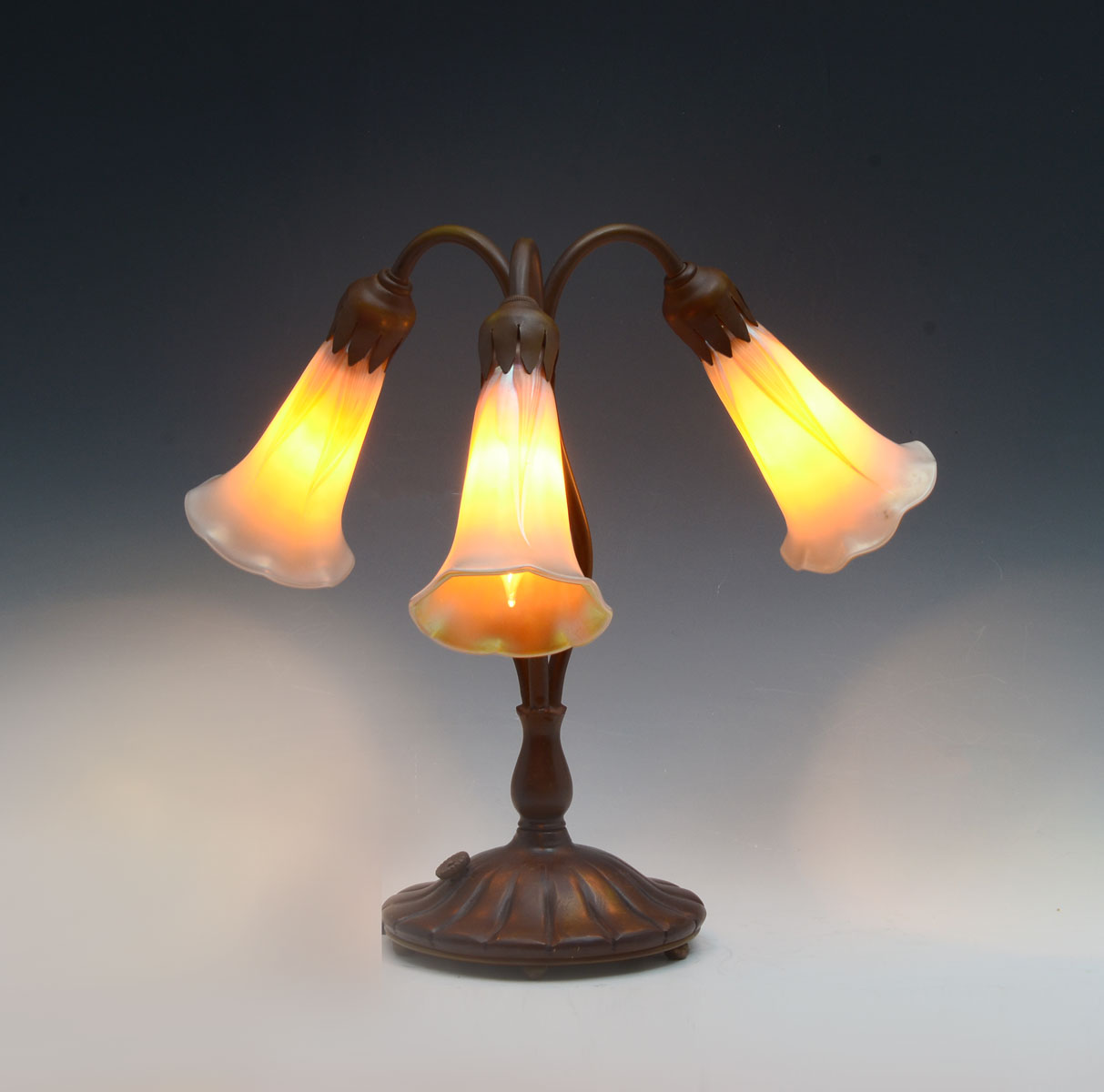 Appraisal: LIGHT TIFFANY LILY LAMP Light Lily lamp having a bronze