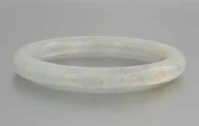 Appraisal: A Carved Jade Bangle Bracelet Smoothly carved and polished jadeite