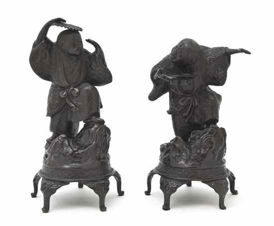 Appraisal: A Pair of Japanese Bronze Figures depicting a youth with