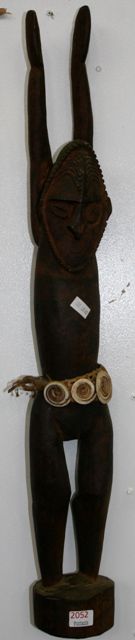 Appraisal: A carved Sepik female figure wearing a woven reed and