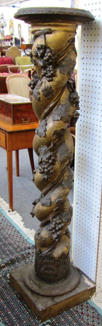 Appraisal: A large spiral fluted parcel gilt column relief moulded with