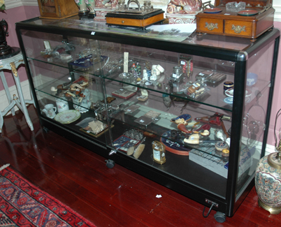 Appraisal: A BLACK METAL BOUND DISPLAY CABINET