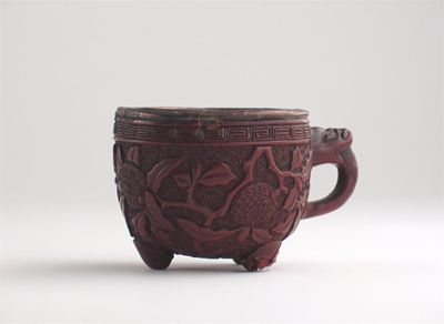 Appraisal: A Chinese red lacquer cup with a loop handle and