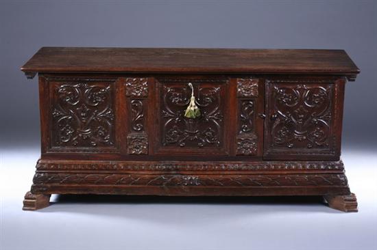 Appraisal: CONTINENTAL CARVED WALNUT TRUNK early th century Hinged lid scrolling