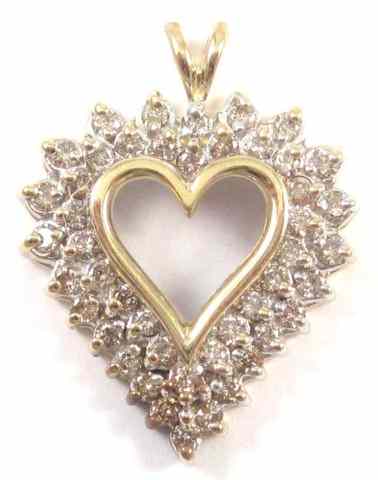 Appraisal: DIAMOND AND TEN KARAT GOLD PENDANT The yellow and white