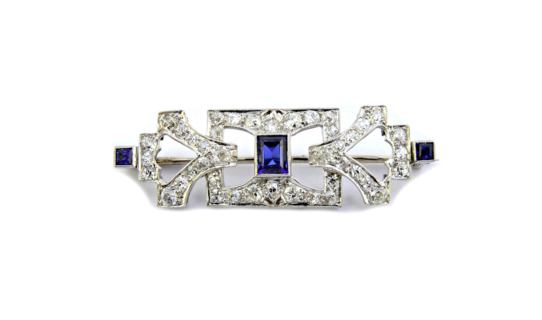 Appraisal: A diamond and synthetic sapphire set brooch in a pierced