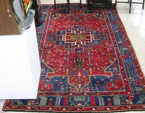 Appraisal: PERSIAN ENTRY CARPET hand knotted in a geometric central medallion