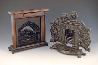 Appraisal: A Victorian miniature cast iron fire place with a recumbent