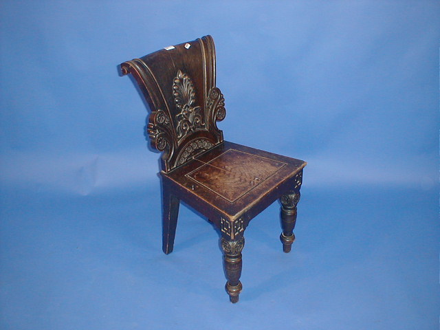 Appraisal: A Victorian carved oak hall chair with scrolling carved anthemion