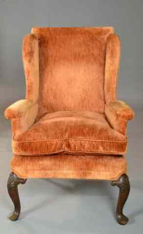 Appraisal: An American Queen Anne Wing ChairWith carved knee returns depicting