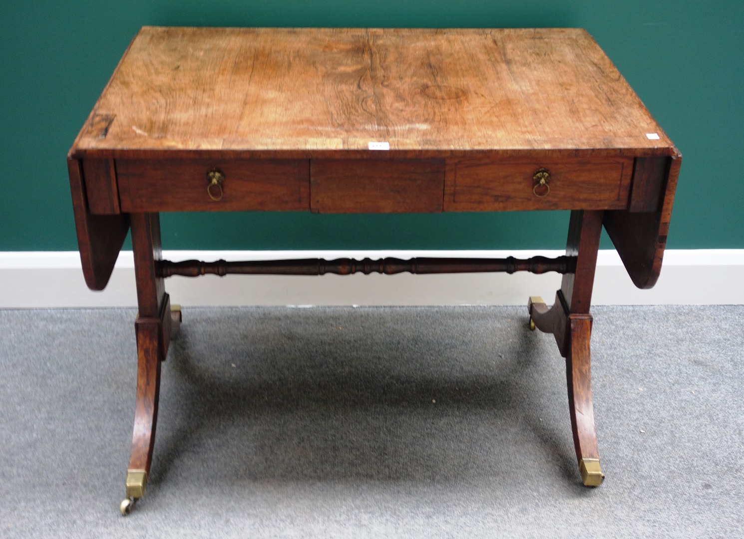 Appraisal: An early th century rosewood sofa table with pair of