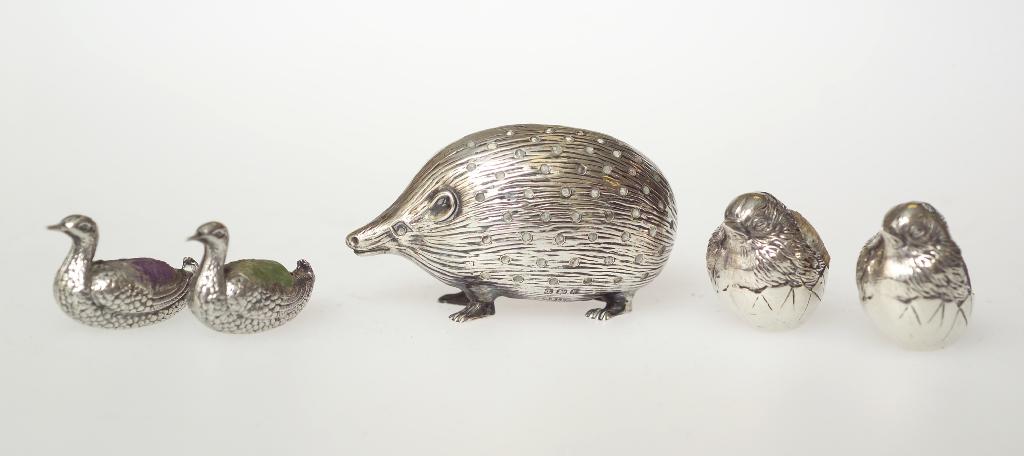 Appraisal: PAIR OF EDWARDIAN SILVER PIN CUSHIONS MODELLED AS HATCHING CHICKS