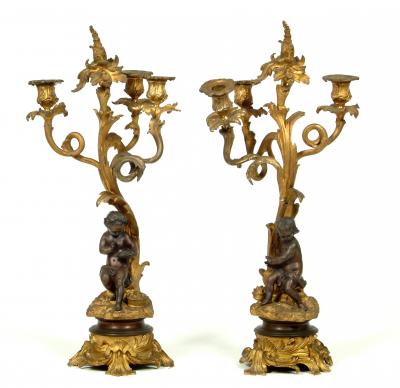 Appraisal: A PAIR OF GILT AND PATINATED BRONZE CANDELABRA each modelled