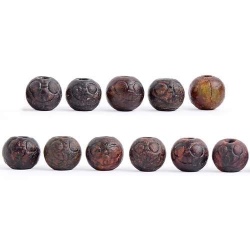 Appraisal: Eleven Chinese brown jade carved beads approx mm diam More