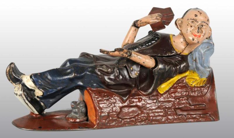 Appraisal: Cast Iron Reclining Chinaman Mechanical Bank Description Manufactured by J