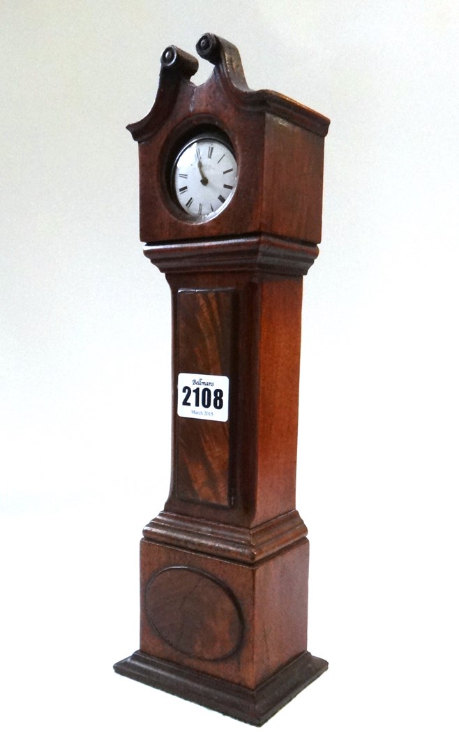 Appraisal: A miniature mahogany cased grandfather clock the hood enclosing a