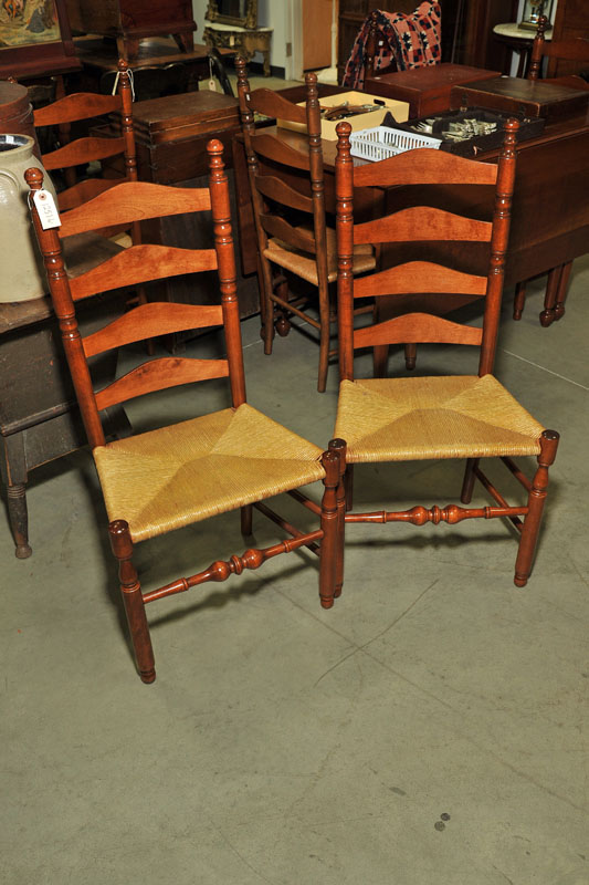 Appraisal: SIX LADDERBACK SIDE CHAIRS Walnut chairs with rush seats and