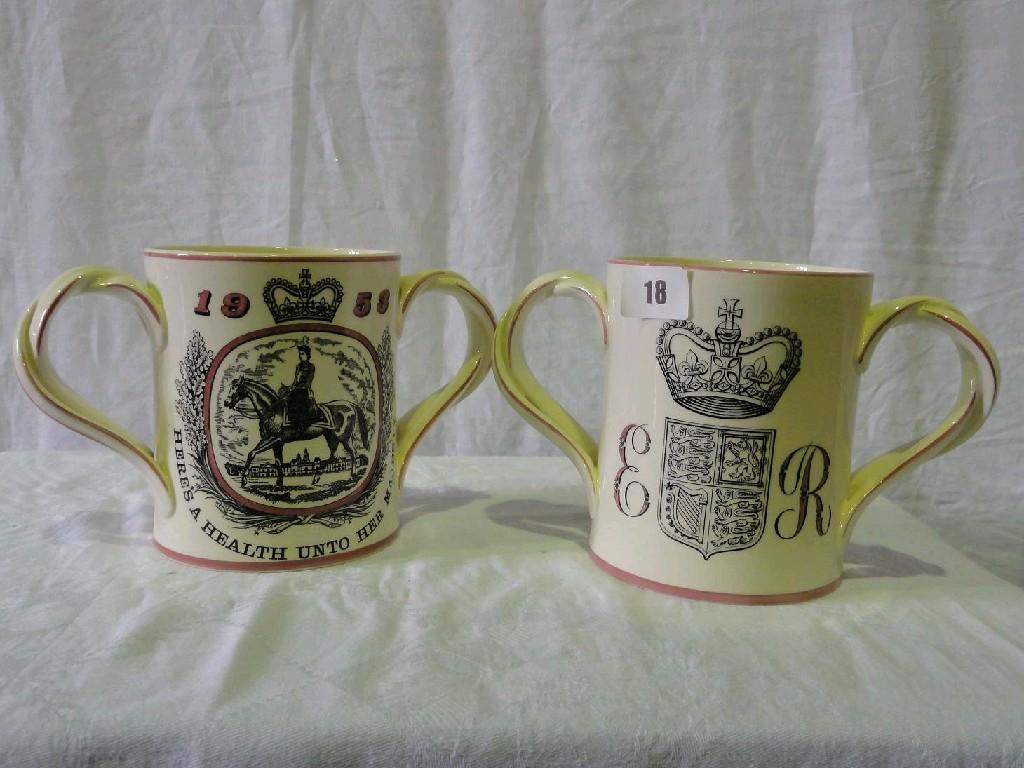 Appraisal: A pair of Royal Doulton loving cups commemorating the Coronation