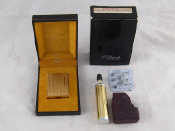 Appraisal: An S T Dupont gold plated cigarette lighter in original