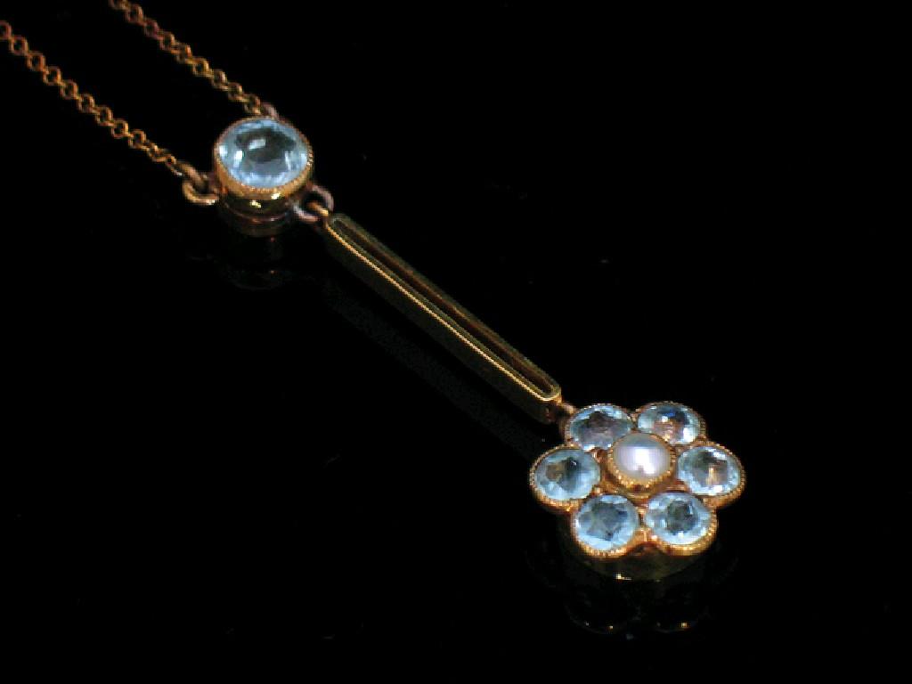 Appraisal: AN EDWARDIAN AQUAMARINE DROP PENDANT the aquamarine and pearl flowerhead