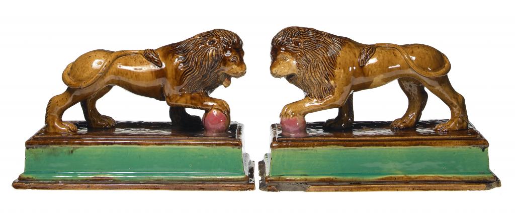 Appraisal: A PAIR OF STAFFORDSHIRE MODELS OF LIONS GEORGE SKEY'S WILNECOTE