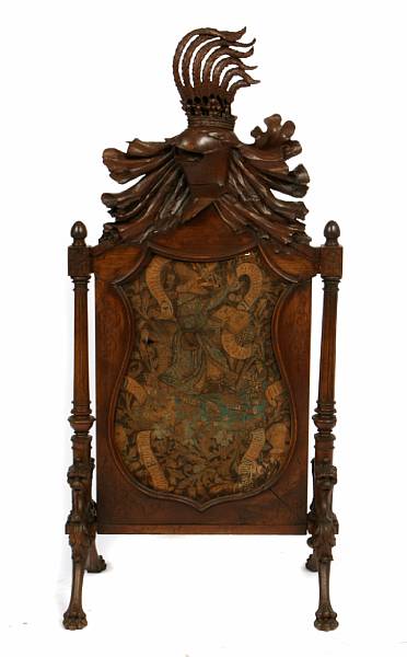 Appraisal: A Continental carved walnut firescreen with heraldic design height ft