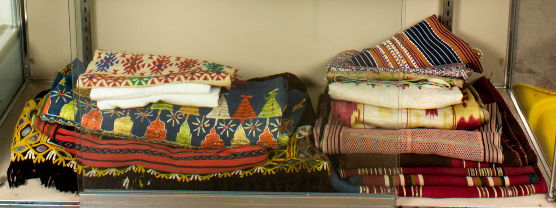 Appraisal: ONE SHELF OF TEXTILES One shelf of textiles including Central