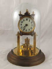 Appraisal: A brass mantel clock with torsion weight movement torsion wire