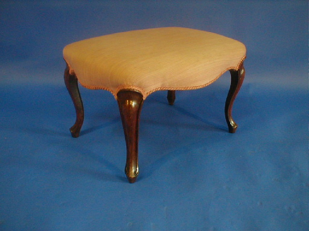 Appraisal: A Victorian walnut serpentine stool with moulded cabriole legs AF