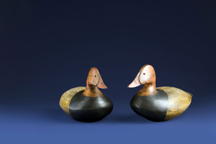 Appraisal: TWO CARVED AND PAINTED CANVASBACK DECOYS Each with glass eyes