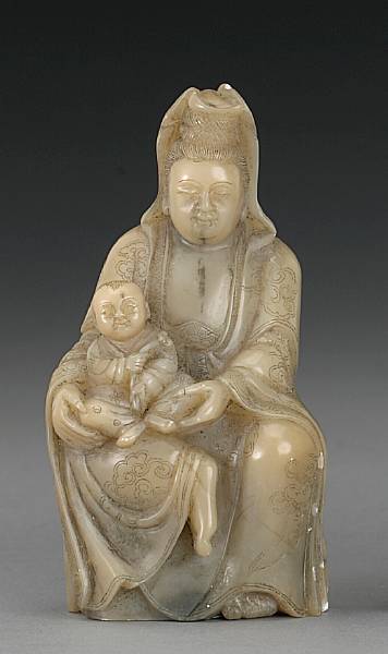 Appraisal: A carved soapstone figure of Guanyin Shown seated and balancing