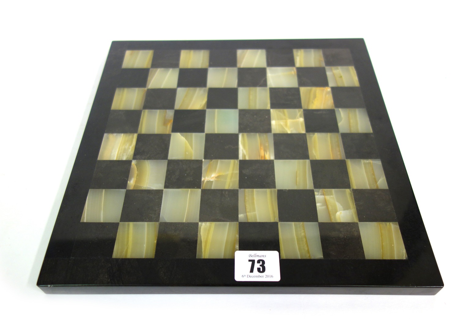 Appraisal: A modern onyx and black marble chess board cm square