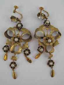 Appraisal: A pair of gilt metal tests silver drop earrings designed