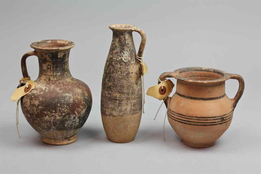 Appraisal: THREE POTTERY VESSELS TWO FLANKING VESSELS ARE CYPRIOT AND THE