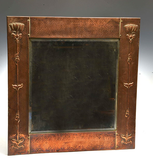 Appraisal: An Arts Crafts hammered copper wall mirror embossed long stemmed