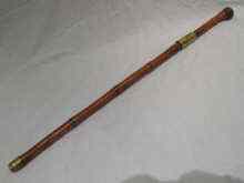 Appraisal: A Chinese bamboo sword stick with brass mounts and incised