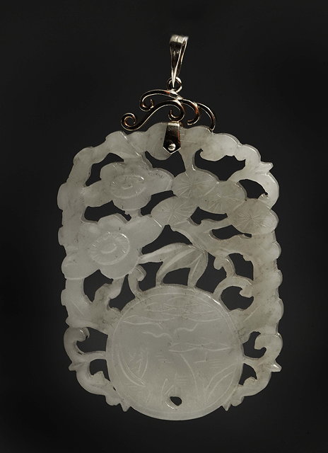 Appraisal: A CHINESE MUTTON FAT JADE PENDANT carved openwork and relief